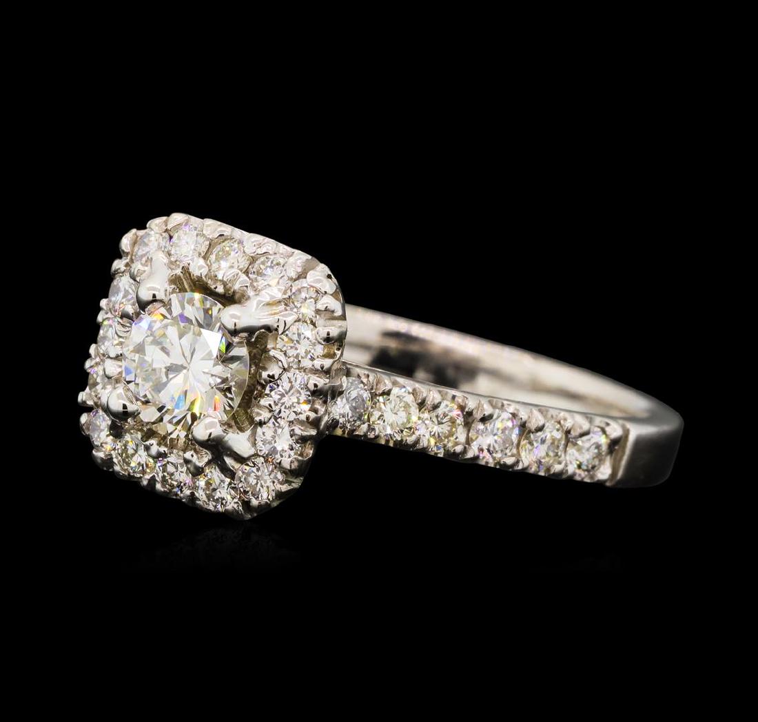 0.89 ctw Diamond Ring - 14KT White Gold: One electronically tested 14KT white gold lady's cast wedding ring with a cathedral cushion halo with a bright polish finish. The featured lady's ring has a shank measuring 2.02 millimeters wide. Iden