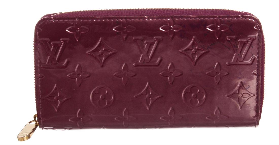 Louis Vuitton Violette Purple Vernis Monogram Zippy: Monogram Vernis leather Louis Vuitton Zippy wallet with brass hardware, tonal leather lining, four interior compartments; one with zip closure, three bill compartments, eight card slots and zip-around