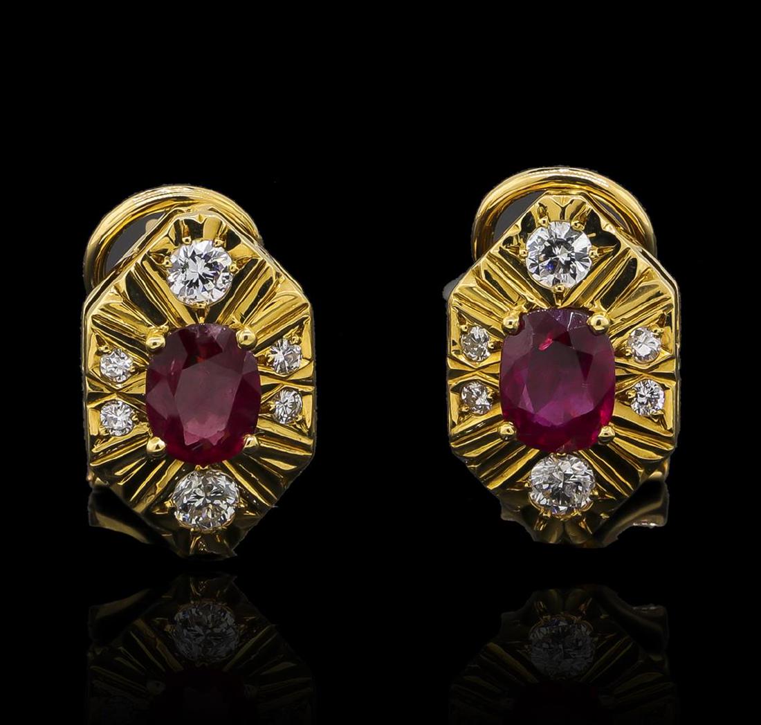 1.40 ctw Ruby and Diamond Earrings - 18KT Yellow Gold: One pair electronically tested 18KT yellow gold ladies cast & assembled ruby and diamond earrings with omega backs. Each earring features a ruby set within a stylized diamond set gallery. Bright polis