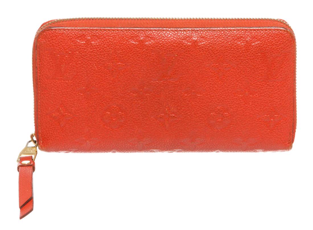 Louis Vuitton Red Empriente Leather Monogram Zippy: Red monogram Empreinte leather Louis Vuitton Zippy wallet with gold-tone hardware, tonal leather lining, dual bill compartments, interior zipper pocket and slit pocket, twelve card slots and zip-aroun
