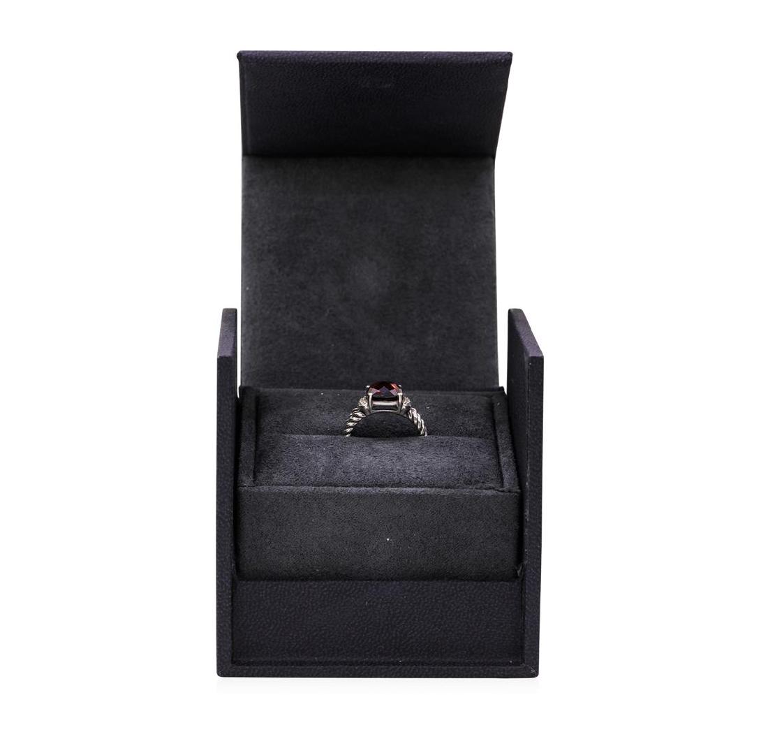 David Yurman 3.10 ctw Garnet and Diamond Ring - Silver: One David Yurman ring featuring: silver weighing 5.2 grams containing one rectangular checkerboard cut cushion shape garnet weighing 3.00ct and diamonds weighing 0.10ctw. The ring is a size 5.