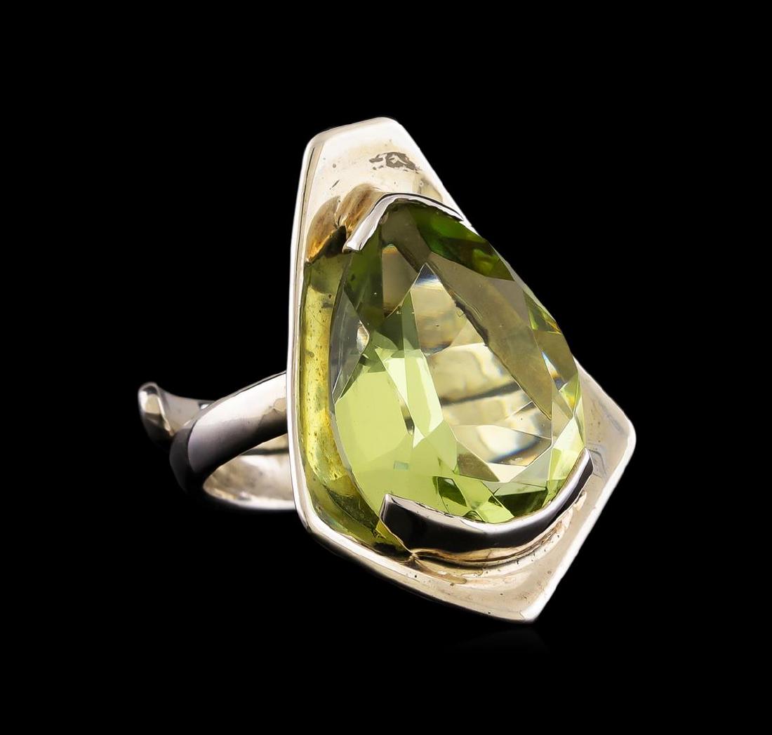 Sterling Silver Ring: One of a kind high fashion sterling silver Ring weighing 7.7 grams. Containing: Imitation Green Beryl. This sterling silver promises a lasting shine.