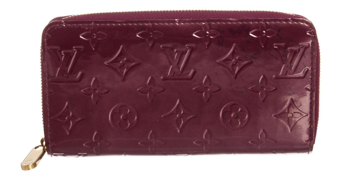 Louis Vuitton Violette Purple Vernis Monogram Zippy: Monogram Vernis leather Louis Vuitton Zippy wallet with brass hardware, tonal leather lining, four interior compartments; one with zip closure, three bill compartments, eight card slots and zip-around