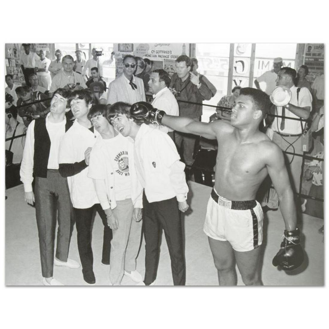 Muhammad Ali Punching The Beatles by Ali, Muhammad: Own a piece of sports history with this Muhammad Ali and Beatles photo. Taken at the peak of his success as one of the greatest heavyweight championship boxers of all time, this photo is sure to compl
