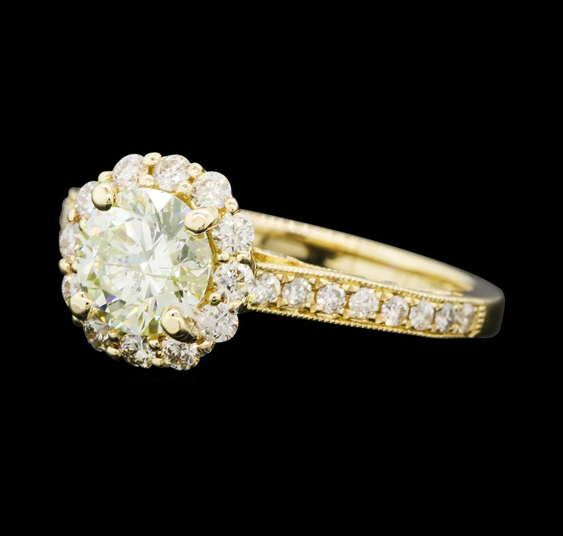1.72 ctw Diamond Ring - 14KT Yellow Gold: One electronically tested 14KT yellow gold lady's cast vintage style wedding ring with a cathedral shank with a basket halo with a bright polish with milgrain detailing finish. The featured lady's rin