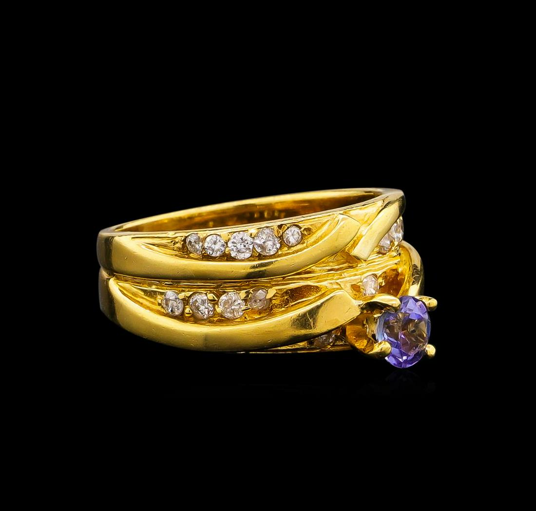 0.45 ctw Tanzanite and Diamond Ring - 18KT Yellow Gold: One set electronically tested 18KT yellow gold lady's combination cast & assembled wedding ring soldered to wedding band with a cathedral shank with a bright polish finish. The featured lady's ring ha