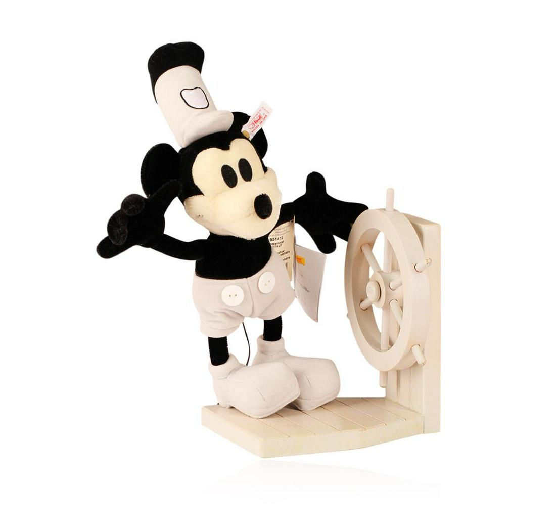Steiff Steamboat Willie Early Mickey Mouse Made With: This is a Steiff "Steamboat Willie". The early role played by Mickey Mouse is reflected in this 22cm mohair piece in black/white. The shoes, trousers and hat are of trevira velvet. He was made in coop