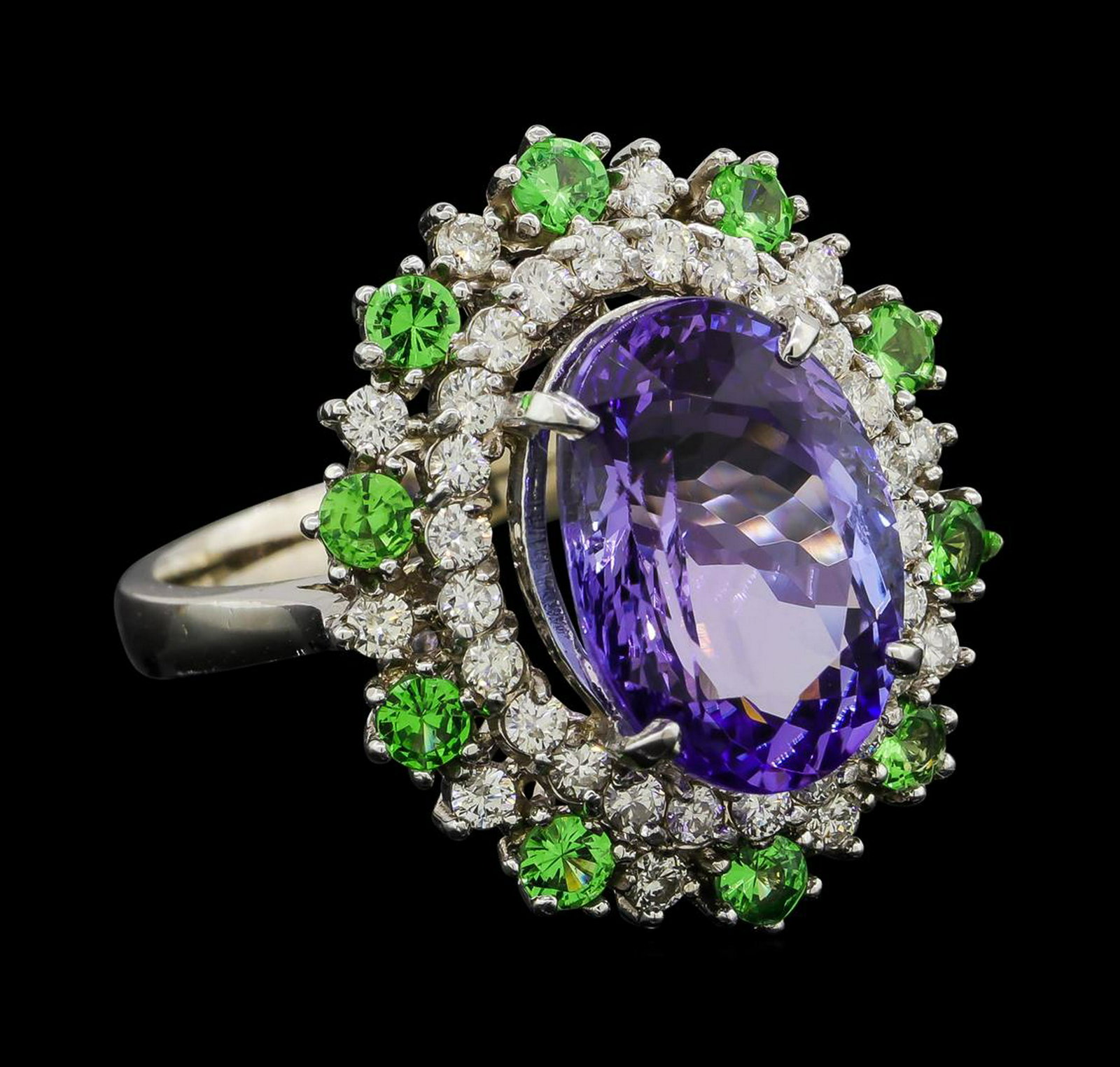 6.20 ctw Tanzanite, Tsavorite and Diamond Ring - 14KT: One electronically tested 14KT white gold lady's cast fashion ring with a double basket halo with a bright polish finish. The featured lady's ring has a shank measuring 2.88 millimeters wide. Identifi