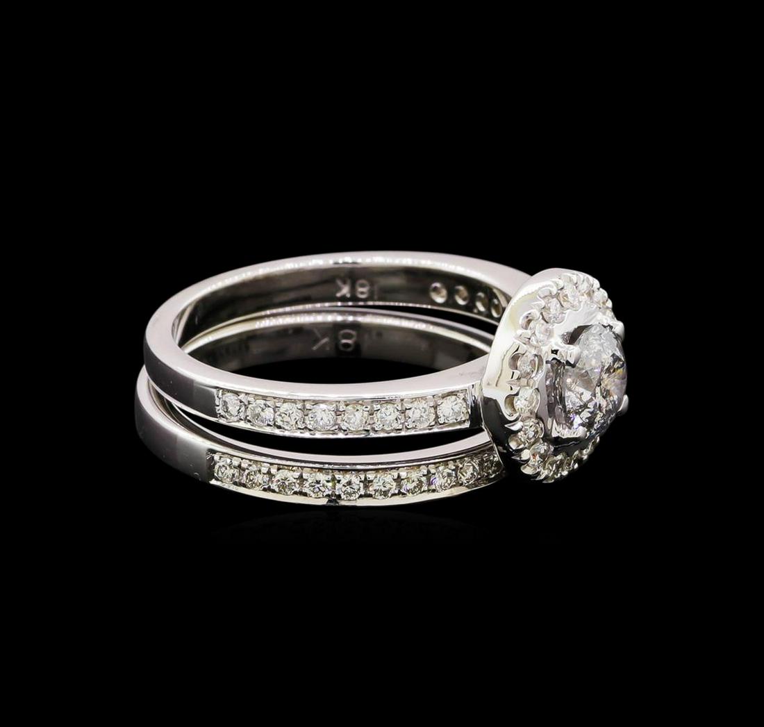 1.30 ctw Diamond Ring - 18KT White Gold: One set electronically tested 18KT white gold lady's cast halo wedding ring with a bright polish finish. The featured lady's ring has a double shank measuring 4.70 millimeters in width. Identified wit