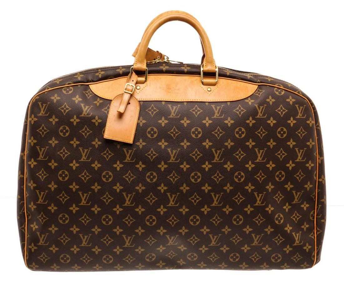 Louis Vuitton Monogram Canvas Leather Alize Lugagge: Brown and tan monogram coated canvas Louis Vuitton Alize luggage with brass hardware, tan vachetta leather trim, luggage tag, detachable woven shoulder strap, dual rolled top handles, beige canvas lin