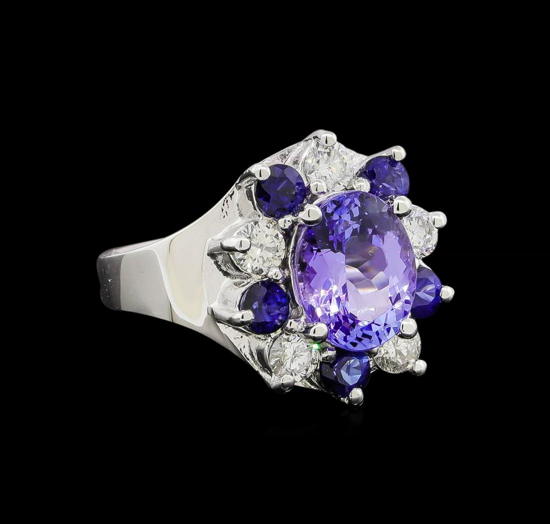 14KT White Gold 2.48 ctw Tanzanite, Sapphire and: One electronically tested 14KT white gold ladies cast tanzinite, sapphire and diamond ring with a bright polish finish. Identified with markings of "K14". Condition is new. Containing: One prong set o