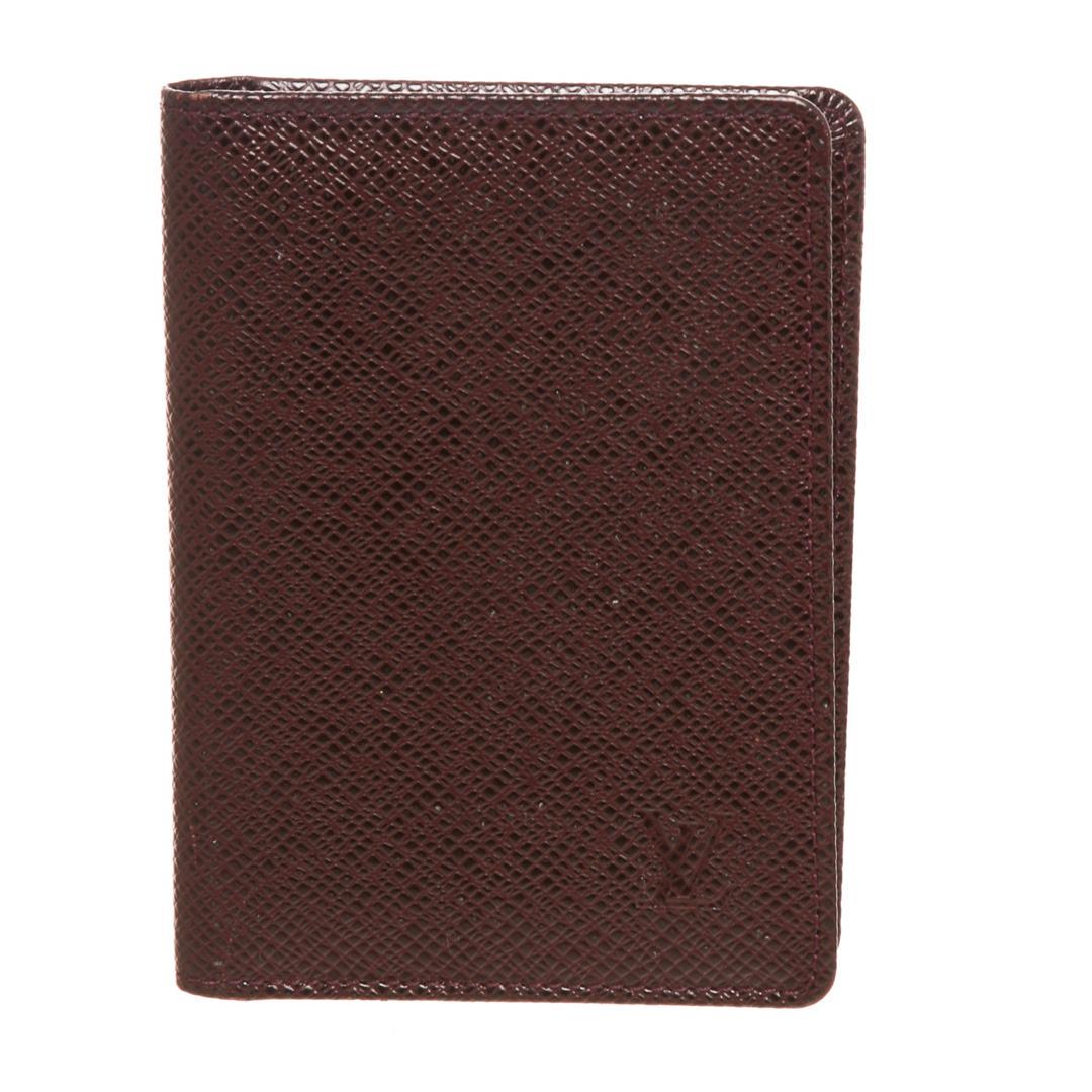 Louis Vuitton Burgundy Taiga Leather ID Holder Wallet: Burgundy Taiga leather Louis Vuitton ID holder with leather interior, dual ID slots at interior walls and fold-over flap closure.