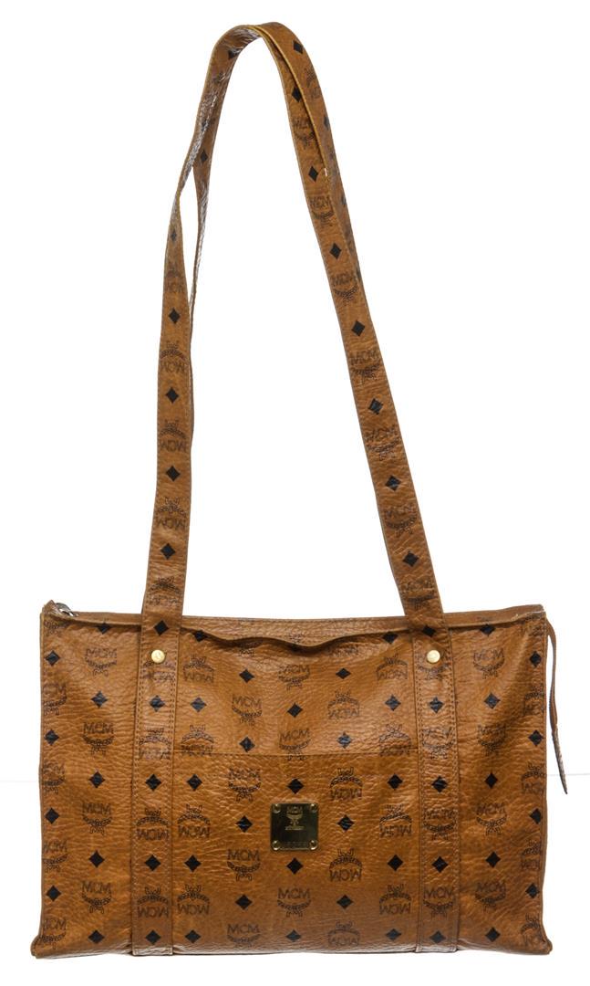 MCM Cognac Visetos Coated Canvas Leather Vintage Large: Cognac MCM visetos coated canvas vintage large tote bag with gold-tone hardware, tonal canvas lining, one side zip pocket and overall zipper top closure. Authentic.