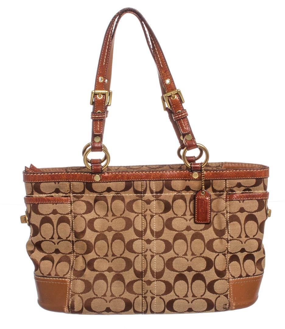 Coach Brown Monogram Canvas Leather Trim Tote Shoulder: Overall open zip top closure. Interior is light brown satin lined with dual slip pockets and one side zip pocket. Exterior tan leather trim and dual flat straps. Authentic.