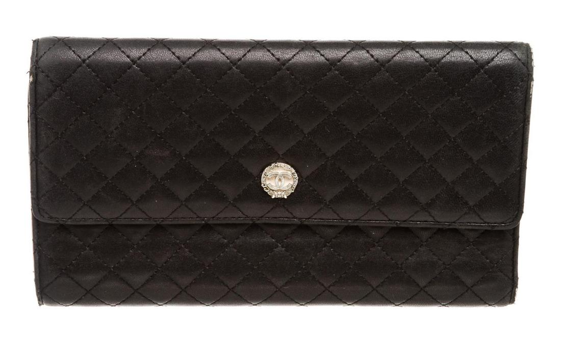 Chanel Black Quilted Leather Trifold Long Wallet: Chanel black quilted leather trifold long wallet with pink leather lining, five pockets, eight card slots, and snap closure. Authentic.