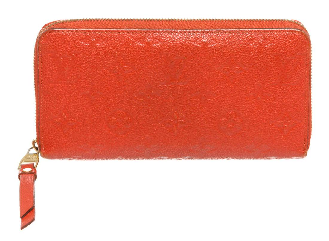 Louis Vuitton Red Empriente Leather Monogram Zippy: Red monogram Empreinte leather Louis Vuitton Zippy wallet with gold-tone hardware, tonal leather lining, dual bill compartments, interior zipper pocket and slit pocket, twelve card slots and zip-aroun