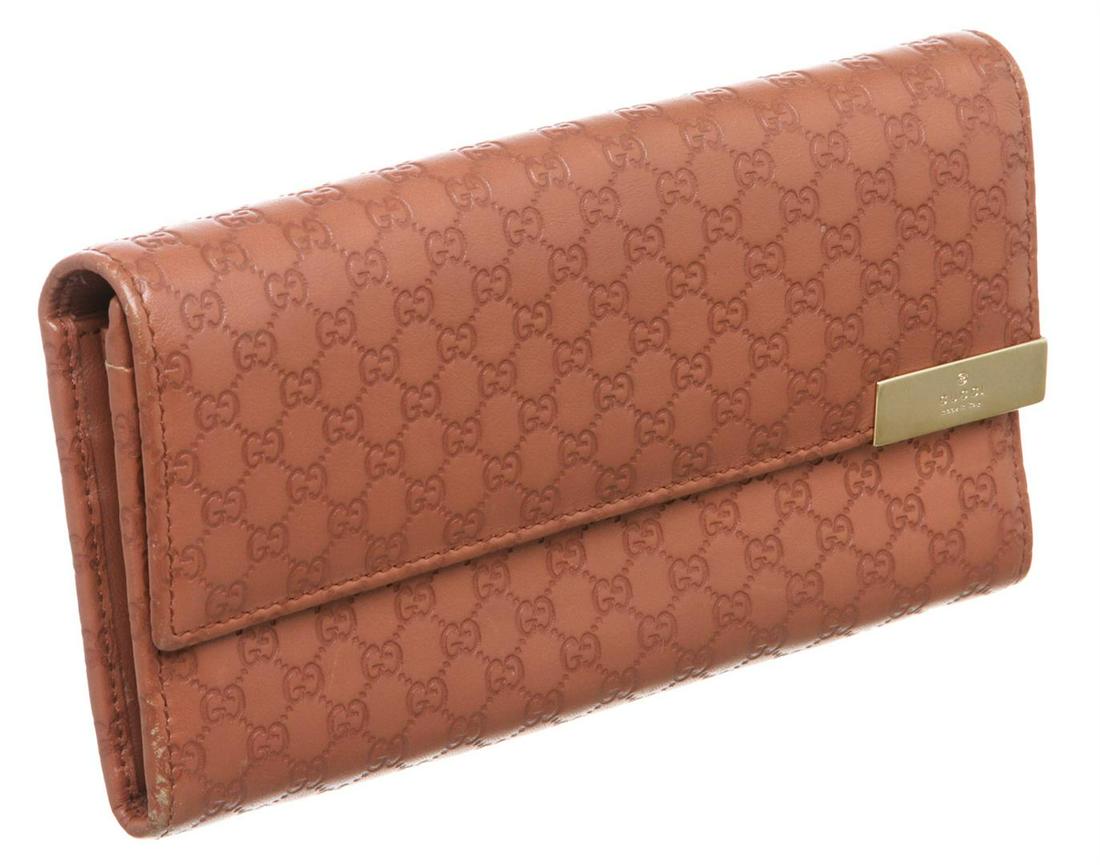 Gucci Mauve Microguccissima Leather Long Wallet: Gucci Mauve Microguccissima leather long wallet with gold-tone hardware, tonal leather lining, center zip pocket, three bill pockets, twelve card slots, flap with snap closure.zip around closure. Auth