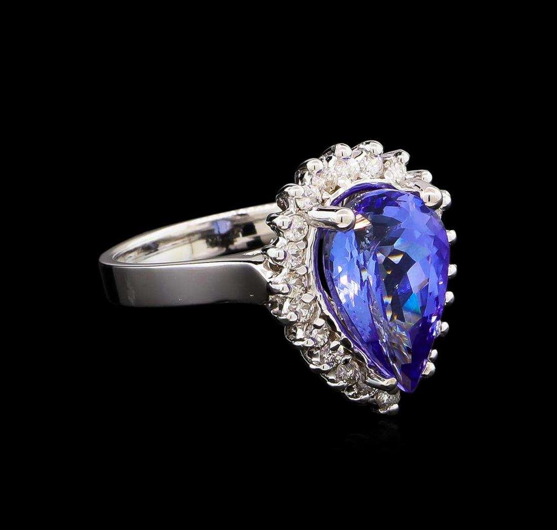 4.08 ctw Tanzanite and Diamond Ring - 14KT White Gold: One electronically tested 14KT white gold lady's cast fashion ring with a basket halo with a bright polish finish. The featured lady's ring has a shank measuring 2.80 millimeters wide. Identified with