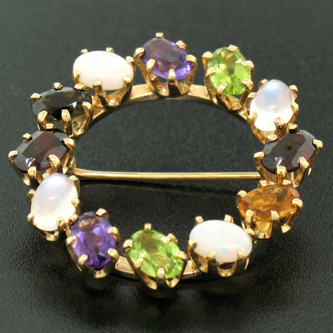 14k Yellow Gold 5.18 ctw Wreath Brooch w/ Amethyst: One 14k Yellow Gold 5.18ctw Wreath Brooch w/ Amethyst Garnet Moonstone Peridot Opal. Item Details: Material: 14k Solid Yellow Gold, Weight: 6.7 Grams, Stone(s): (2) Natural Genuine Amethysts - Oval Cu