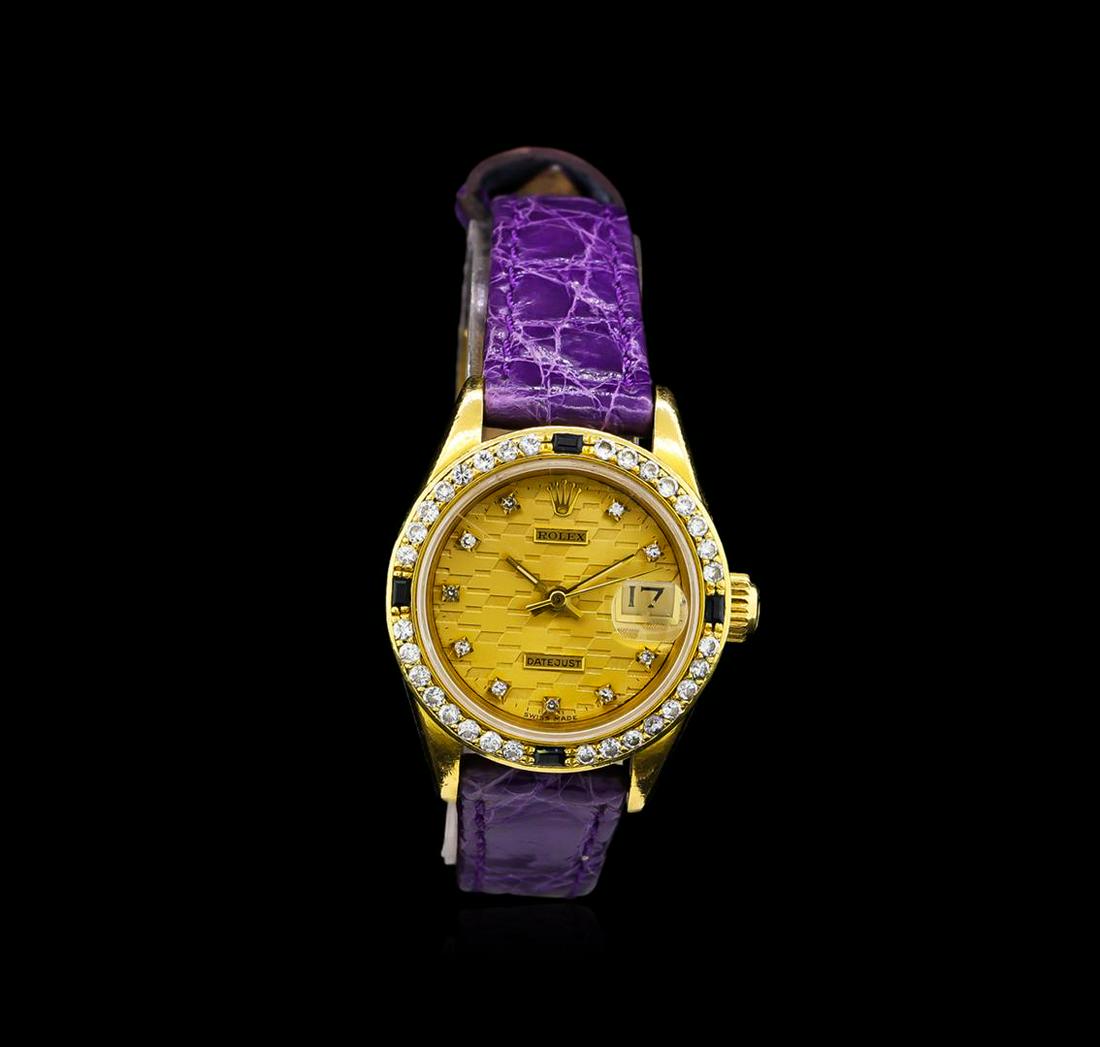 Rolex 18KT Gold Diamond and Sapphire DateJust Ladies: One ladies, hand crafted & machine milled Rolex DateJust model wristwatch electronically tested 18KT yellow gold, Swiss Hallmarked Case: 26mm oyster, Case Back: Personalized engraving, Crown: twinlock