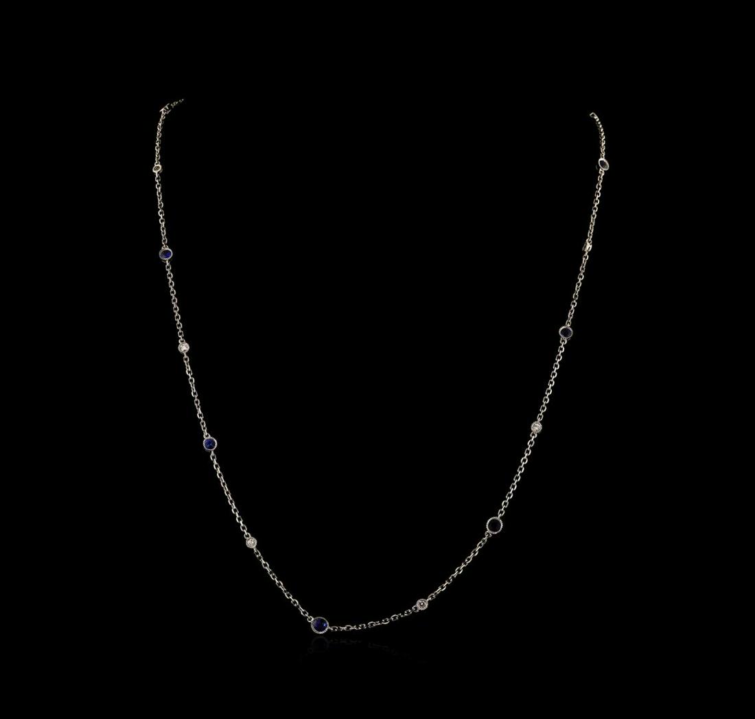 2.20 ctw Blue Sapphire and Diamond Necklace - 18KT: One electronically tested 18KT white gold lady's combination cast & assembled diamonds by the yard necklace with a lobster claw clasp with a bright polish with milgrain detailing finish. The featured 