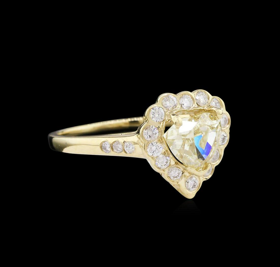 1.60 ctw Fancy Light Yellow Diamond Ring - 14KT Yellow: One electronically tested 14KT yellow gold lady's cast fashion ring with a cathedral shank with a bright polish finish. The featured lady's ring has a shank measuring 1.19 millimeters wide. Identified