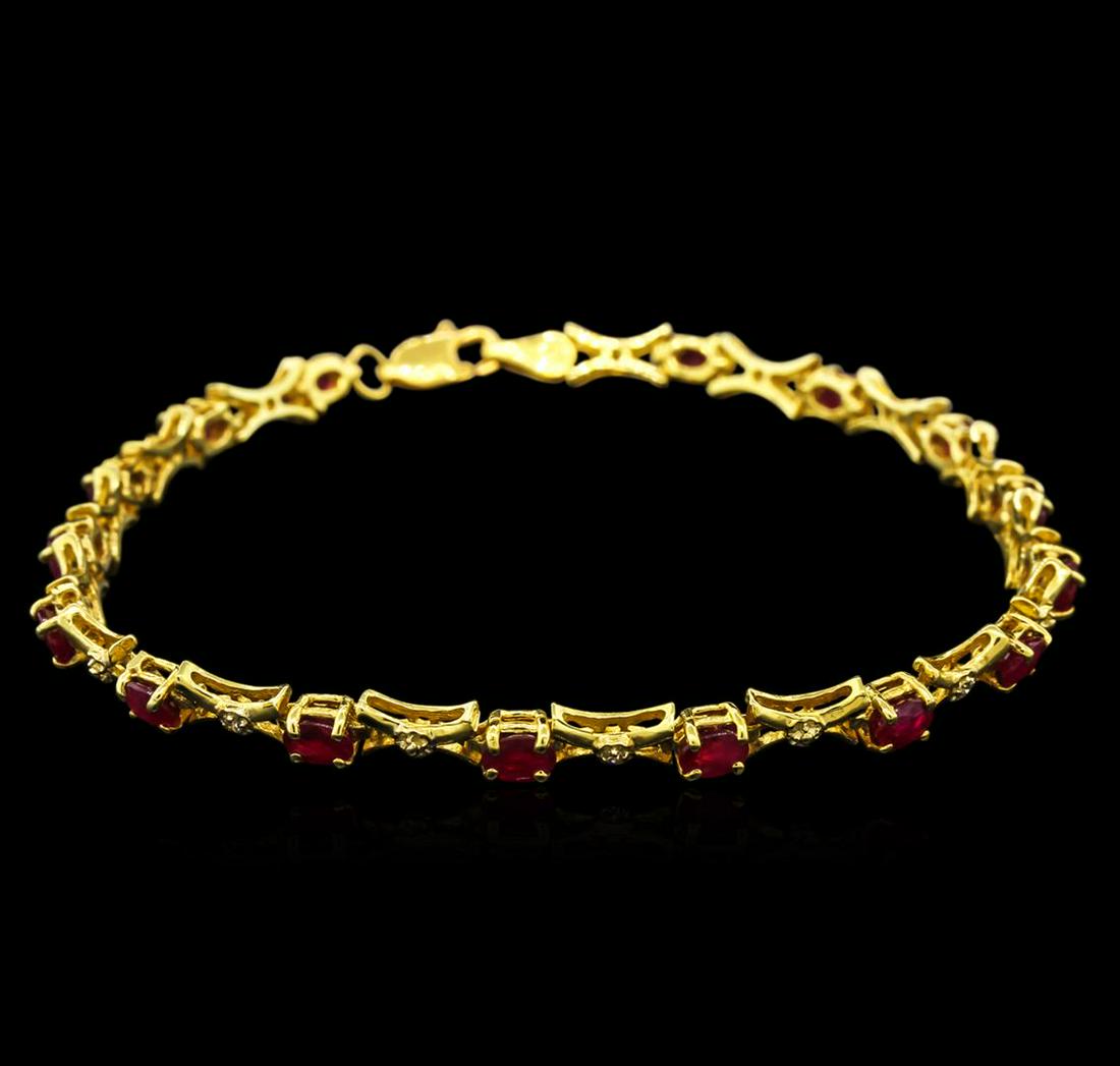 10KT Yellow Gold 3.50 ctw Ruby and Diamond Bracelet: One tennis bracelet featuring: 10KT yellow gold weighing 5.60 grams containing rubies with a total weight of 3.50ct and diamonds with a total weight of 0.10ct.