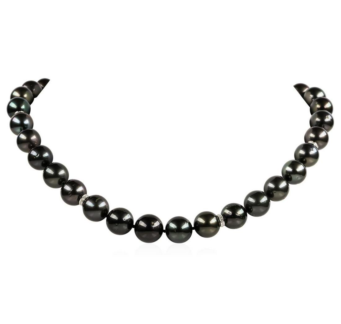 Pearl and Diamond Necklace: One graduated single strand pearl necklace 18" princess length, knotted with a spring ring clasp containing 35 Tahitian pearls, 14.3mm to 11.1mm in size. The pearls are black in color, green overtone 