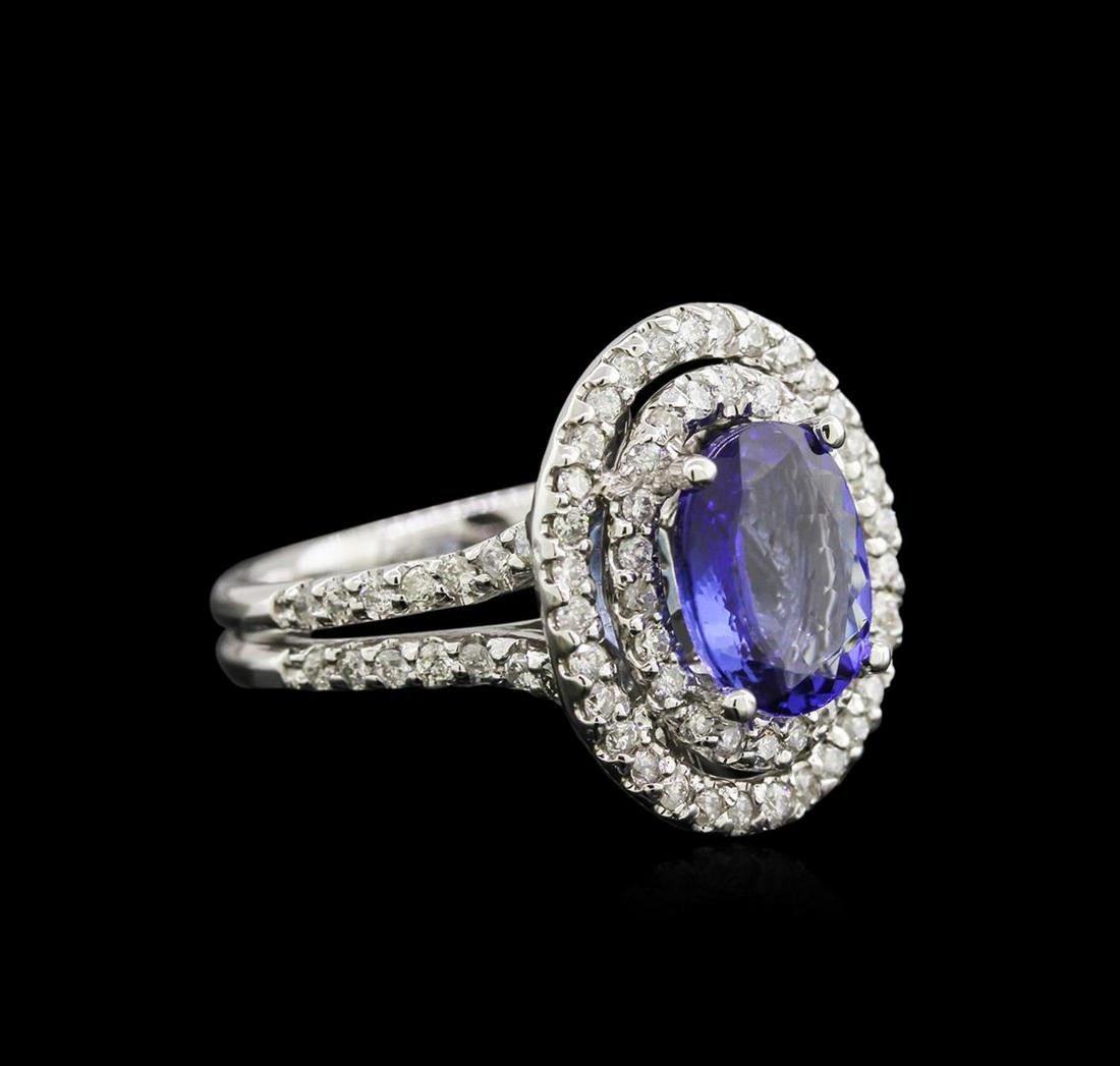 2.22 ctw Tanzanite and Diamond Ring - 14KT White Gold: One electronically tested 14KT white gold lady's cast fashion ring with a split shank with a bright polish finish. The featured lady's ring has a double halo motif with a shank measuring 3.20 millimet