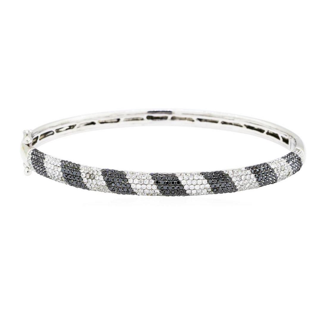 2.50 ctw Black and White Diamond Bangle Bracelet - 14KT: One electronically tested 14KT white gold lady's combination cast & assembled fashion bangle bracelet with a tongue clasp with double foldover safeties with a bright polish finish. The featured lady's