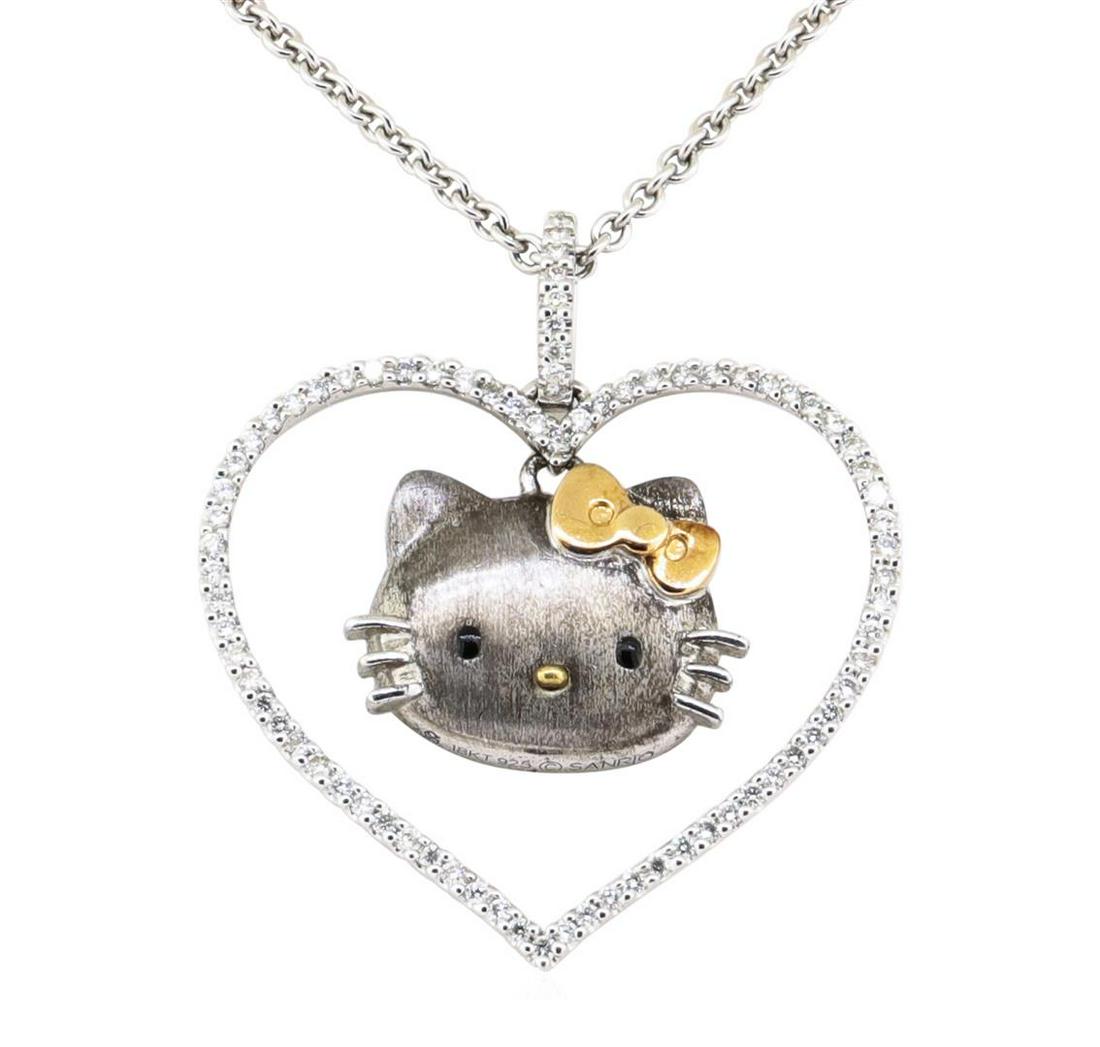 Sanrio 0.60 ctw Heart Shaped Hello Kitty Diamond: One Sanrio Hello Kitty heart shaped pendant with chain featuring: .925 silver and 18KT white gold weighing 14.0 grams containing diamonds weighing 0.60ctw. The chain is a 1.8mm rounded cable link chai