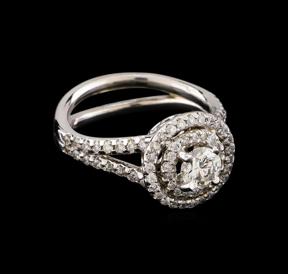 1.14 ctw Diamond Ring - 14KT White Gold: One electronically tested 14KT white gold lady's cast wedding ring with a split shank double basket halo with a bright polish finish. The featured lady's ring has a double shank measuring 3.20 millime