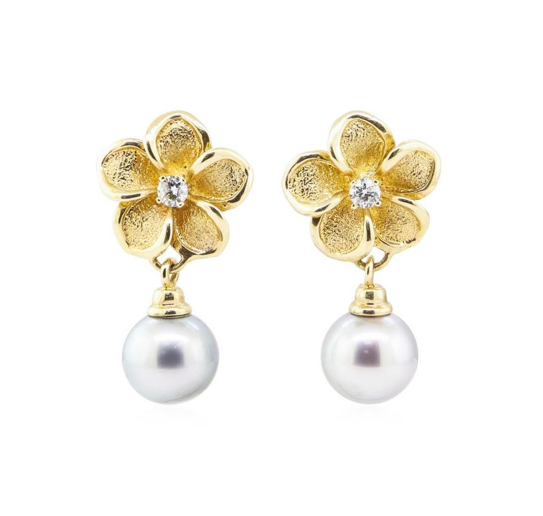 0.20 ctw Diamond and Tahitian Pearl Plumeria Earrings -: One pair of plumeria earrings featuring: 14KT yellow gold weighing 6.3 grams containing two diamonds weighing 0.20ctw and two black Tahitian pearls measuring approximately 9.0 millimeters in diameter.