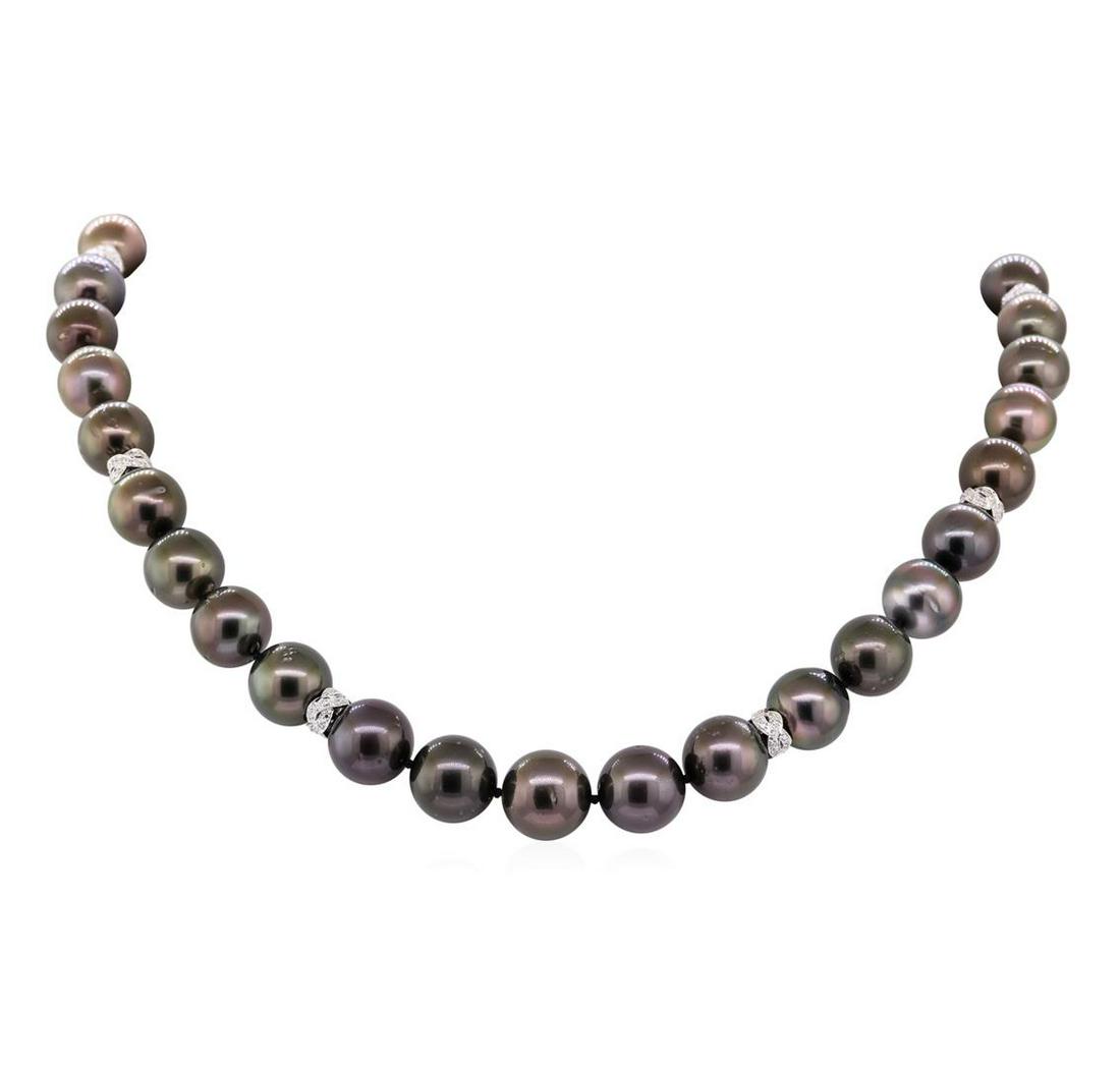 0.75 ctw Diamond and Tahitian Pearl Necklace - 14KT: One graduated single strand pearl necklace 18.0' princess length, knotted with a tongue clasp & foldover safety containing 35 Tahitian pearls, 11.0mm to 13.7mm in size. The pearls are peacock in color