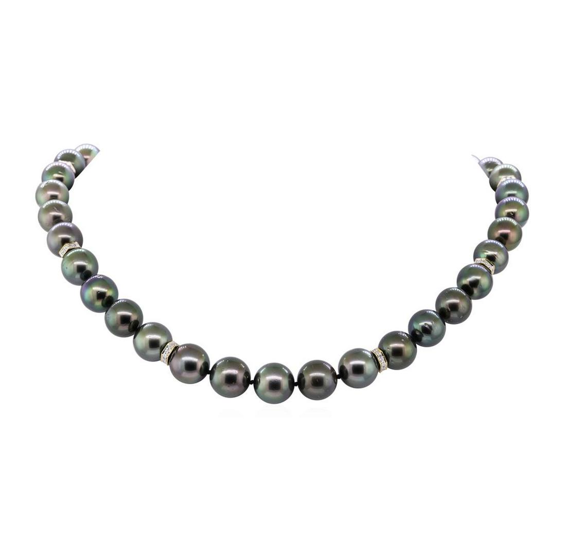 0.75 ctw Diamond and Tahitian Pearl Necklace - 14KT: One graduated single strand pearl necklace 18.0' princess length, knotted with a foldover buckle clasp containing 35 Tahitian pearls, 11.0mm to 13.5mm in size. The pearls are black in color, green ove