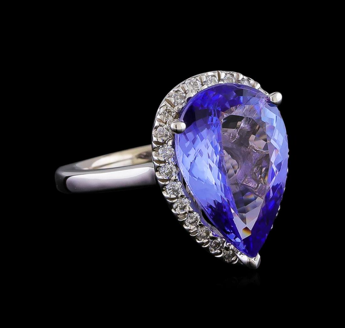 5.82 ctw Tanzanite and Diamond Ring - 14KT White Gold: One electronically tested 14KT white gold lady's cast fashion ring with a cathedral halo with a bright polish finish. The featured lady's has a shank measuring 1.85 millimeters in width. Identified wi