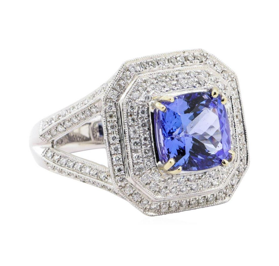5.17 ctw Tanzanite and Diamond Ring - 14KT White Gold: One electronically tested 14KT white gold ladies cast tanzanite and diamond ring. The featured tanzanite is set with two tiered diamond bezels supported by diamond set split shoulders, completed by a 