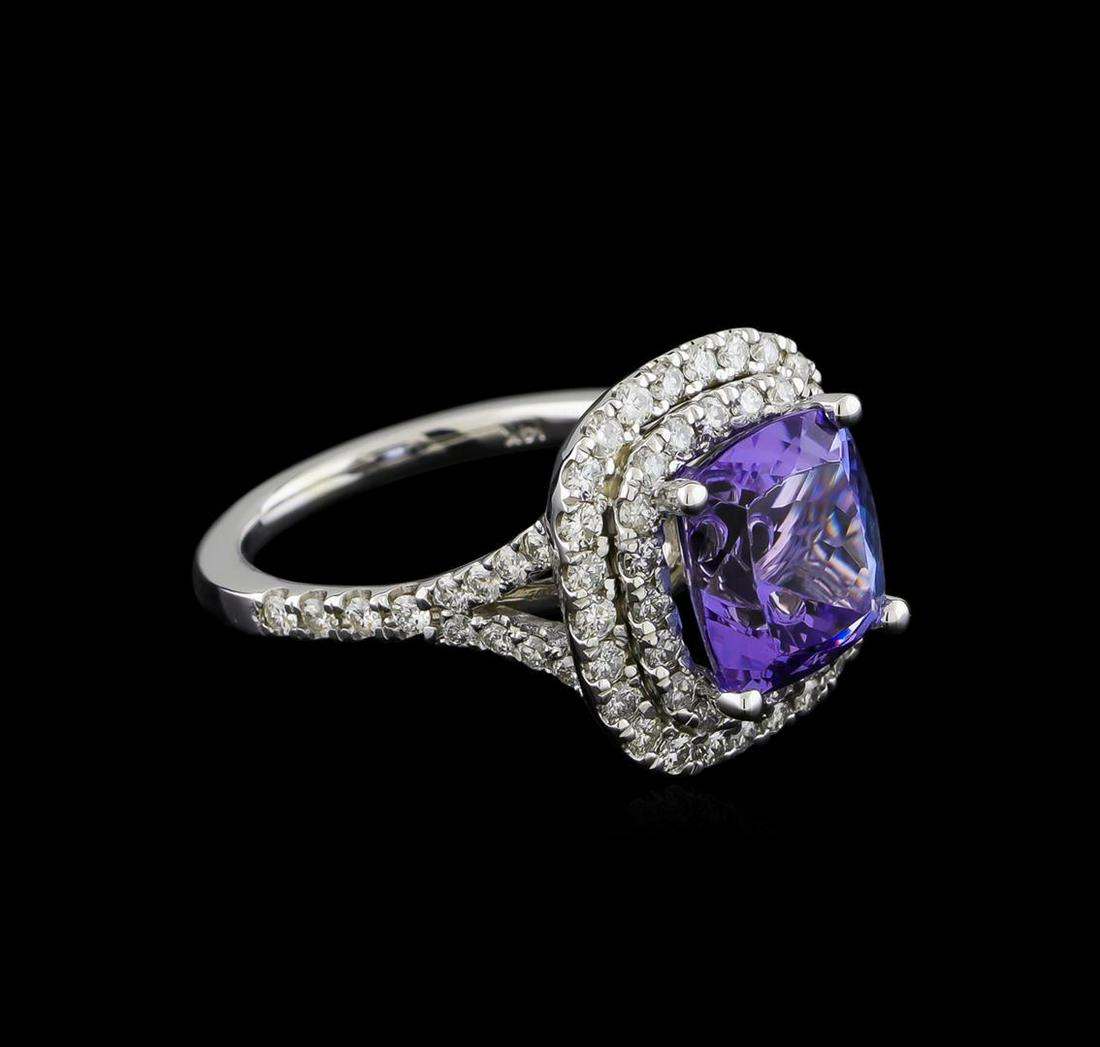 4.12 ctw Tanzanite and Diamond Ring With Chain - 14KT: One electronically tested 14KT white gold lady's cast fashion ring with a split shank double halo with a bright polish finish. The featured lady's ring has a shank measuring 1.71 millimeters wide. Ide