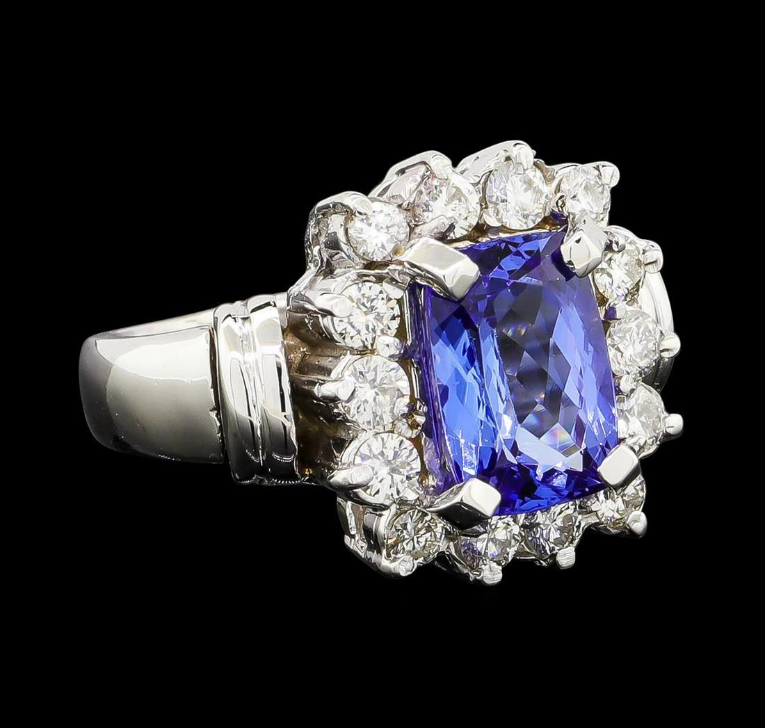 2.93 ctw Tanzanite and Diamond Ring - 14KT White Gold: One electronically tested 14KT white gold lady's cast fashion ring with a cathedral shank with a basket halo with a bright polish finish. The featured lady's ring has two double-wire cuffs set on the 