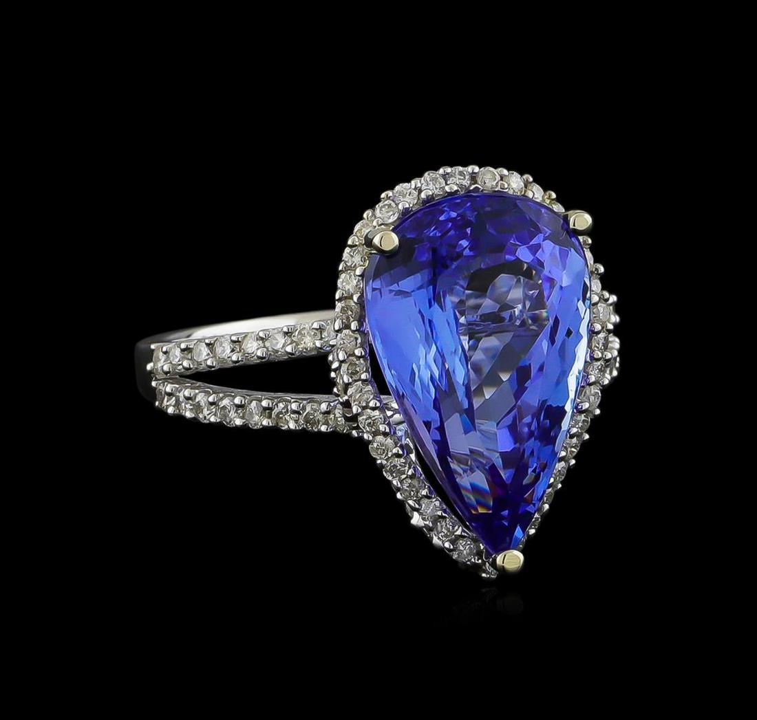 7.11 ctw Tanzanite and Diamond Ring - 14KT White Gold: One electronically tested 14KT white gold ladies cast tanzanite and diamond ring with a bright polish finish. The featured tanzanite is set within a diamond bezel supported by a diamond set under gall