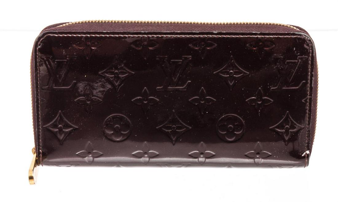 Louis Vuitton Amarante Vernis Leather Monogram Zippy: Amarante Monogram Vernis leather Louis Vuitton Zippy wallet with brass hardware, tonal leather lining, four interior compartments; one with zip closure, three bill compartments, eight card slots and z
