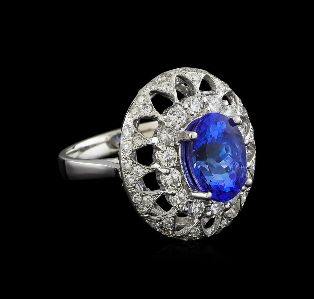 14KT White Gold 3.03 ctw Tanzanite and Diamond Ring: One electronically tested 14KT white gold ladies combination cast & assembled ring with a bright polish finish. Condition is new. Containing: One prong set oval modified brilliant cut natural tanzanit