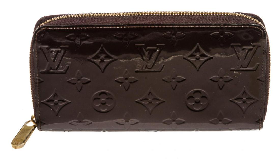 Louis Vuitton Amarante Vernis Monogram Zippy Wallet: Amarante Monogram Vernis leather Louis Vuitton Zippy wallet with brass hardware, tonal leather lining, four interior compartments; one with zip closure, three bill compartments, eight card slots and z