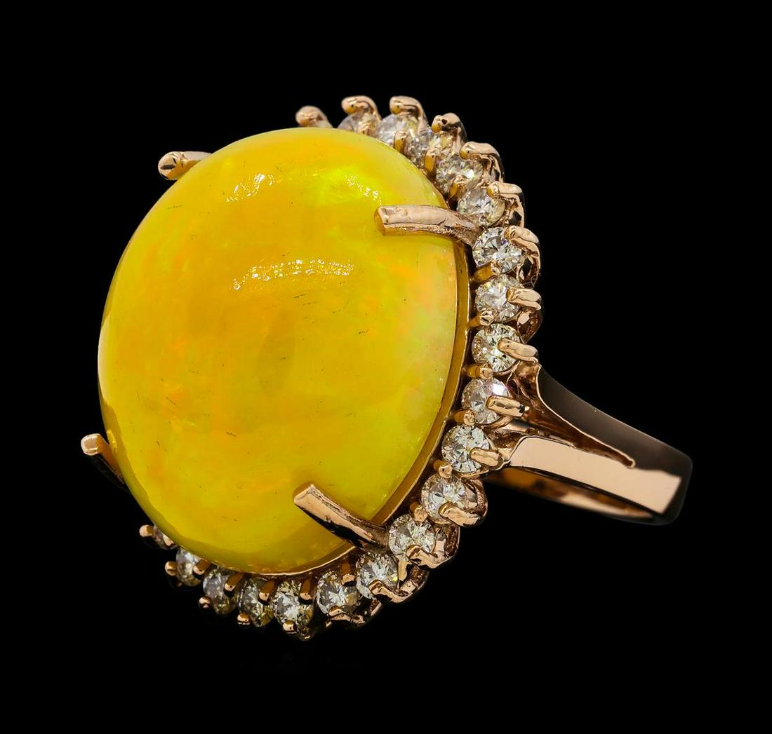 25.28 ctw Opal and Diamond Ring - 14KT Rose Gold: One electronically tested 14KT rose gold lady's cast fashion ring with a split shank basket halo with a bright polish finish. The featured lady's ring has a shank measuring 3.21 millimeters wide. Iden