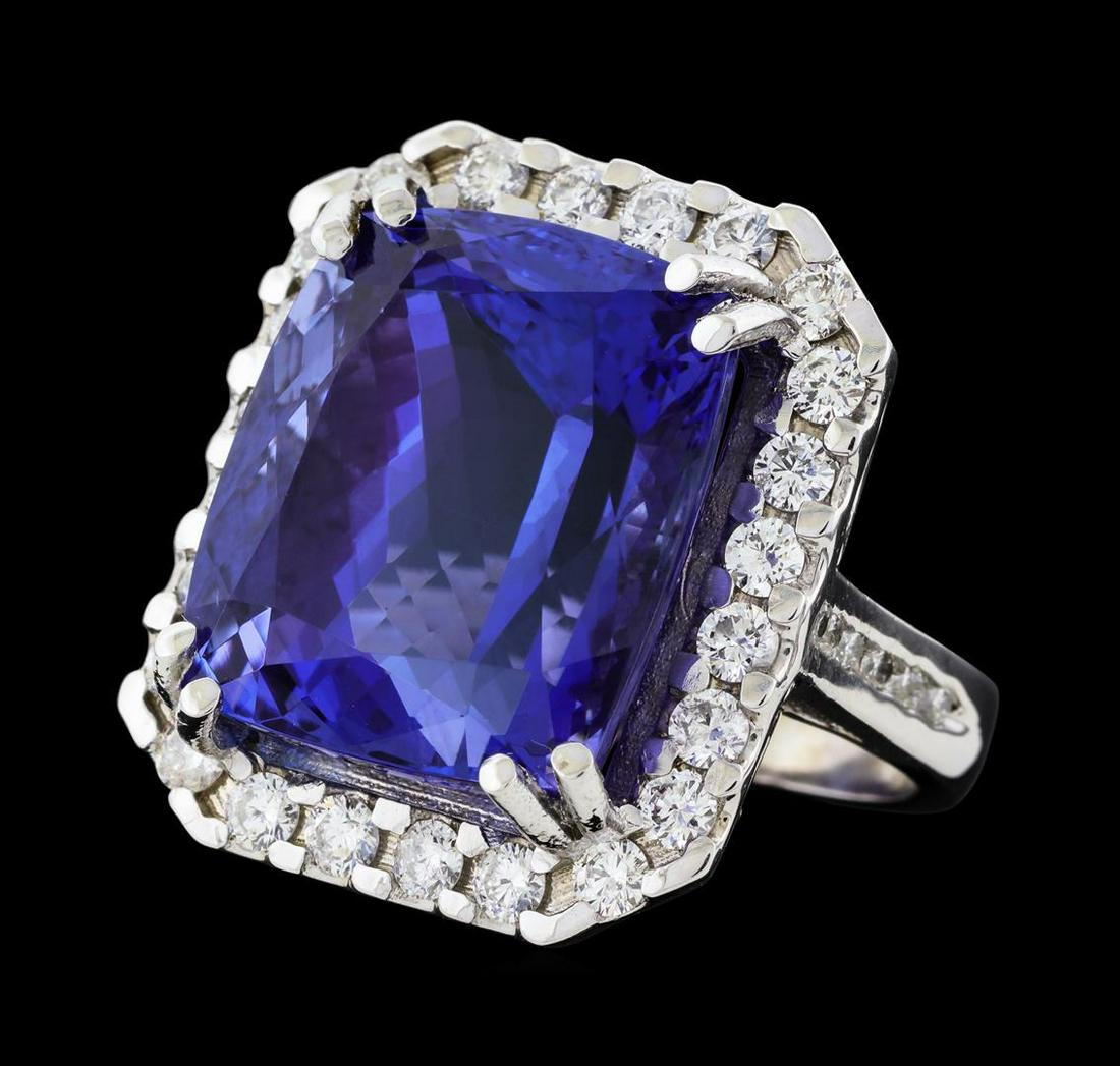 31.45 ctw Tanzanite and Diamond Ring - 14KT White Gold: One electronically tested 14KT white gold lady's cast fashion ring with a cathedral shank with a basket halo with a bright polish finish. The featured lady's ring has a shank measuring 3.60 millimeter