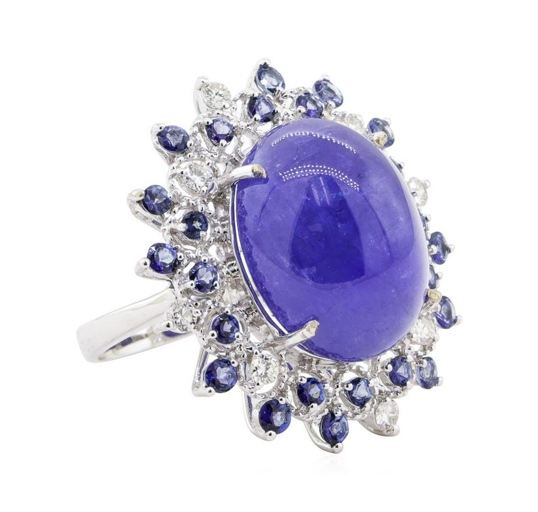 26.38 ctw Tanzanite and Diamond Ring - 14KT White Gold: One polished, stamped, and tested 14K white gold ring mounted with: 25 genuine tannish weighing 26.38 carats, and 8 genuine round diamonds weighing 0.42 carats. This item weighs 12.6 grams, condition 