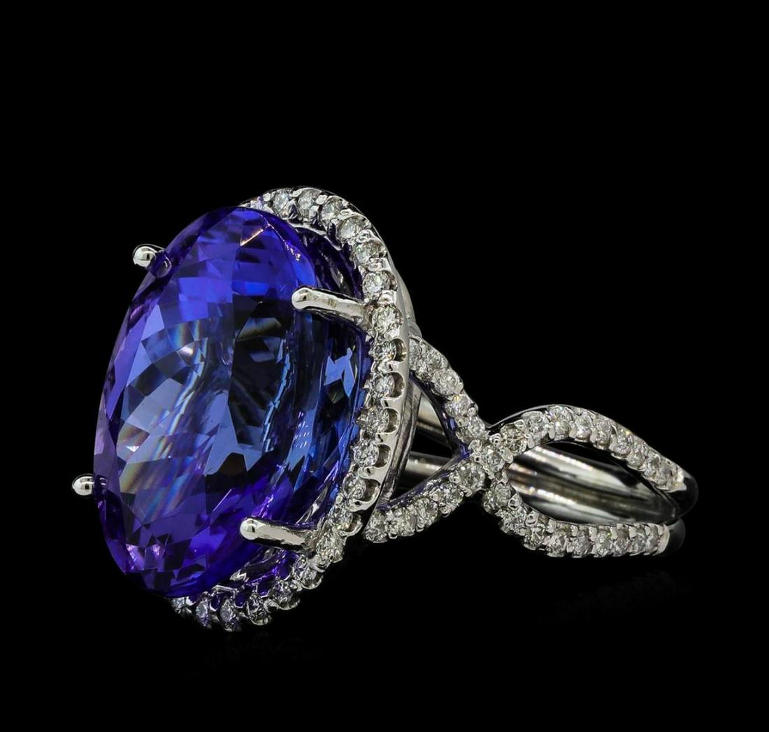 17.09 ctw Tanzanite and Diamond Ring - 14KT White Gold: One electronically tested 14KT white gold ladies cast tanzanite and diamond ring with a bright polish finish. The featured tanzanite is set within a diamond bezel supported by a lattice under gallery 