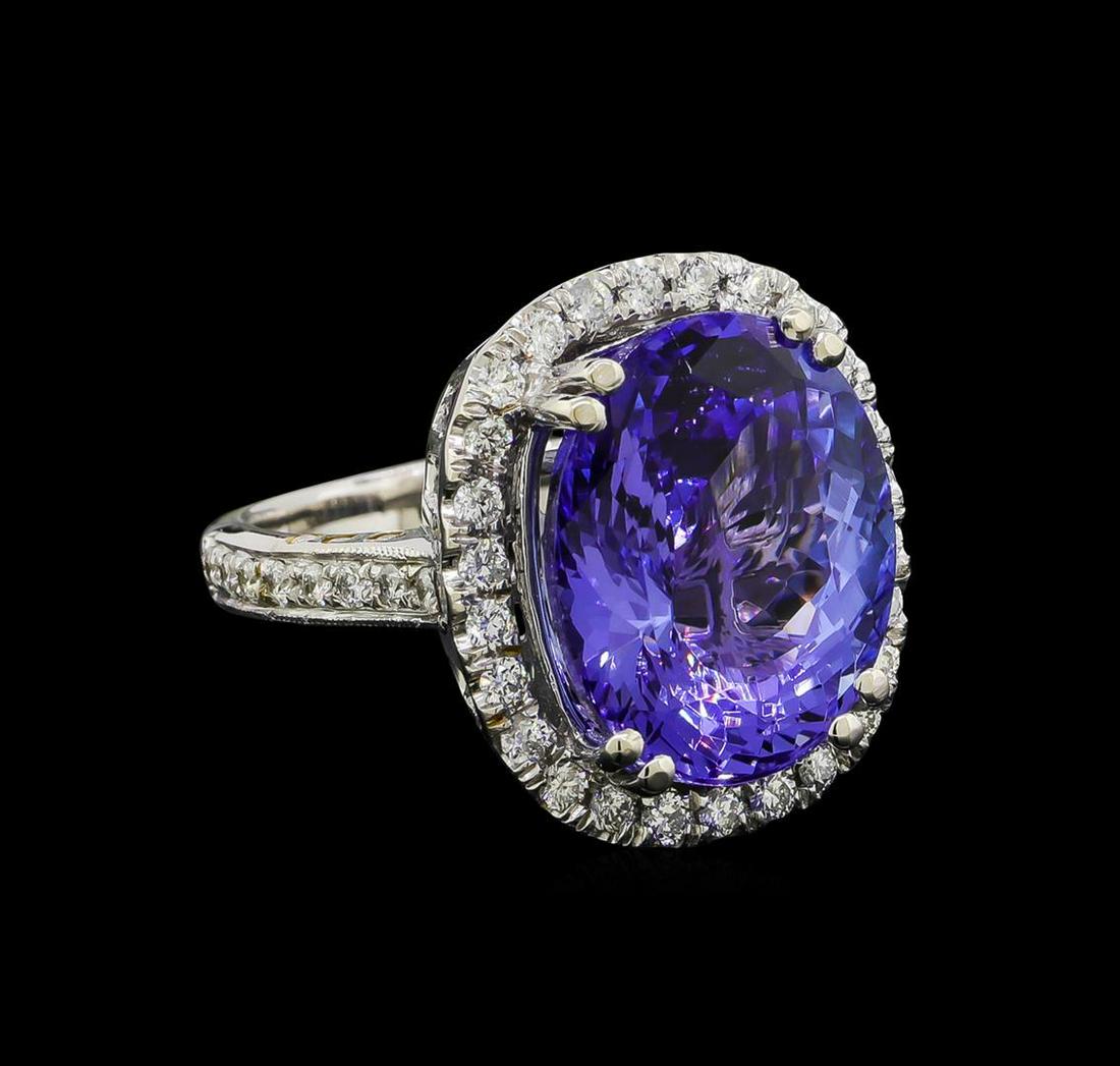 10.35 ctw Tanzanite and Diamond Ring - 14KT White Gold: One electronically tested 14KT white gold lady's cast fashion ring with a basket halo with a bright polish with milgrain detailing finish. The featured lady's ring has a diamond set shank measuring 2.