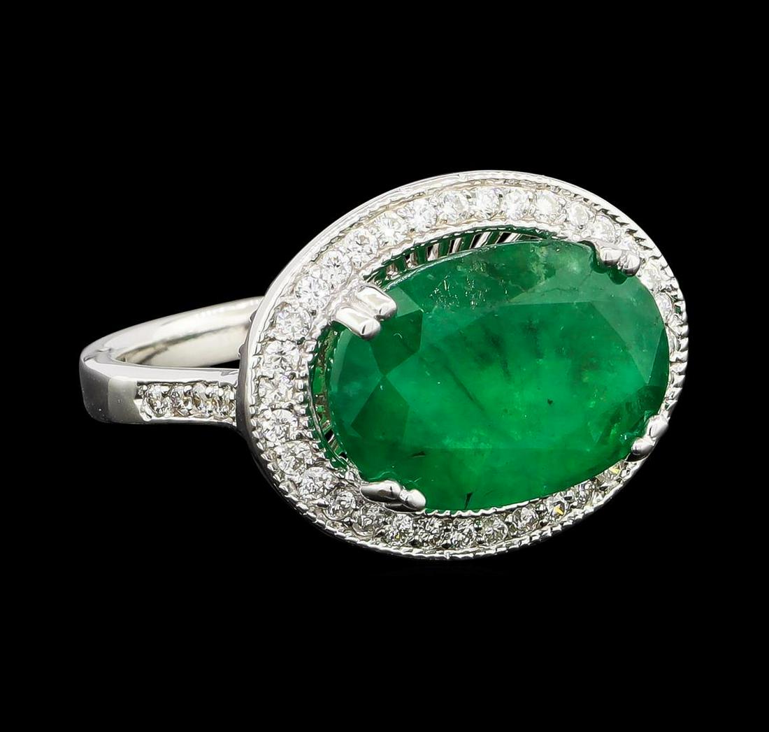 5.95 ctw Emerald and Diamond Ring - 14KT White Gold: One electronically tested 14KT white gold lady's cast fashion ring with a basket halo with a bright polish with milgrain detailing finish. The featured lady's ring has a shank measuring 2.63 millimete