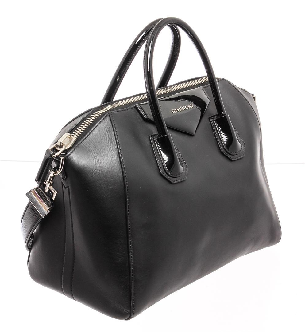 Givenchy Black Leather Medium Antigona Satchel Shoulder: Givenchy black leather medium antigona satchel shoulder bag with silver-tone hardware, single leather shoulder strap and dual rolled top handles, black canvas lining, three interior pockets; one with 